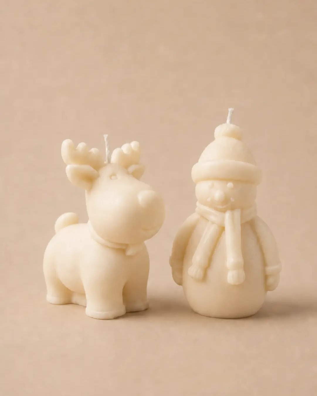 The Merry, a reindeer candle and a snowman candle